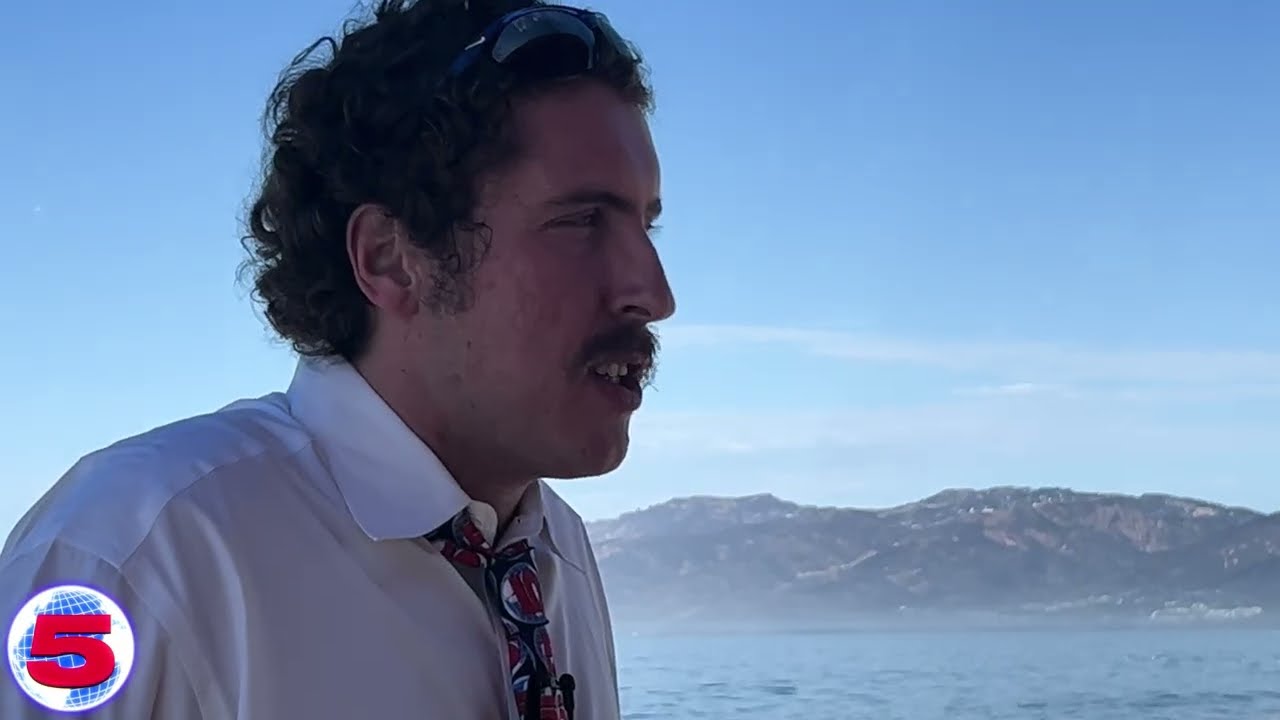 Andrew Callaghan mid-sentence on a boat off the California coast during the Addressing Hunter Biden Crypto Coin video