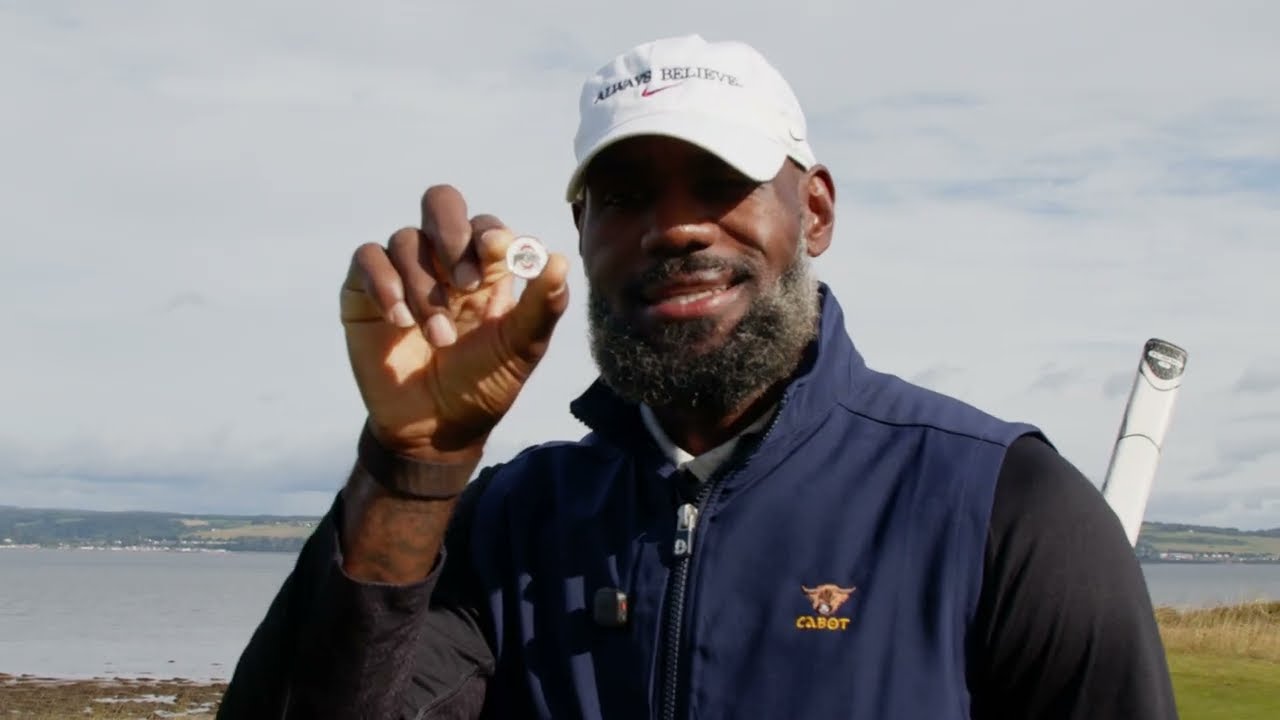 LeBron James holding up a ball marker at Cabot Highlands in episode two of his golf YouTube channel