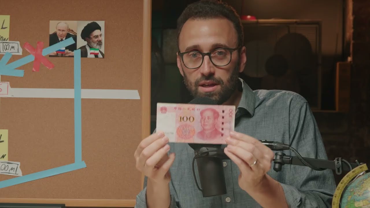 Max Fisher holding a 100-yuan note in front of his cork-board during the July 17 breakout video